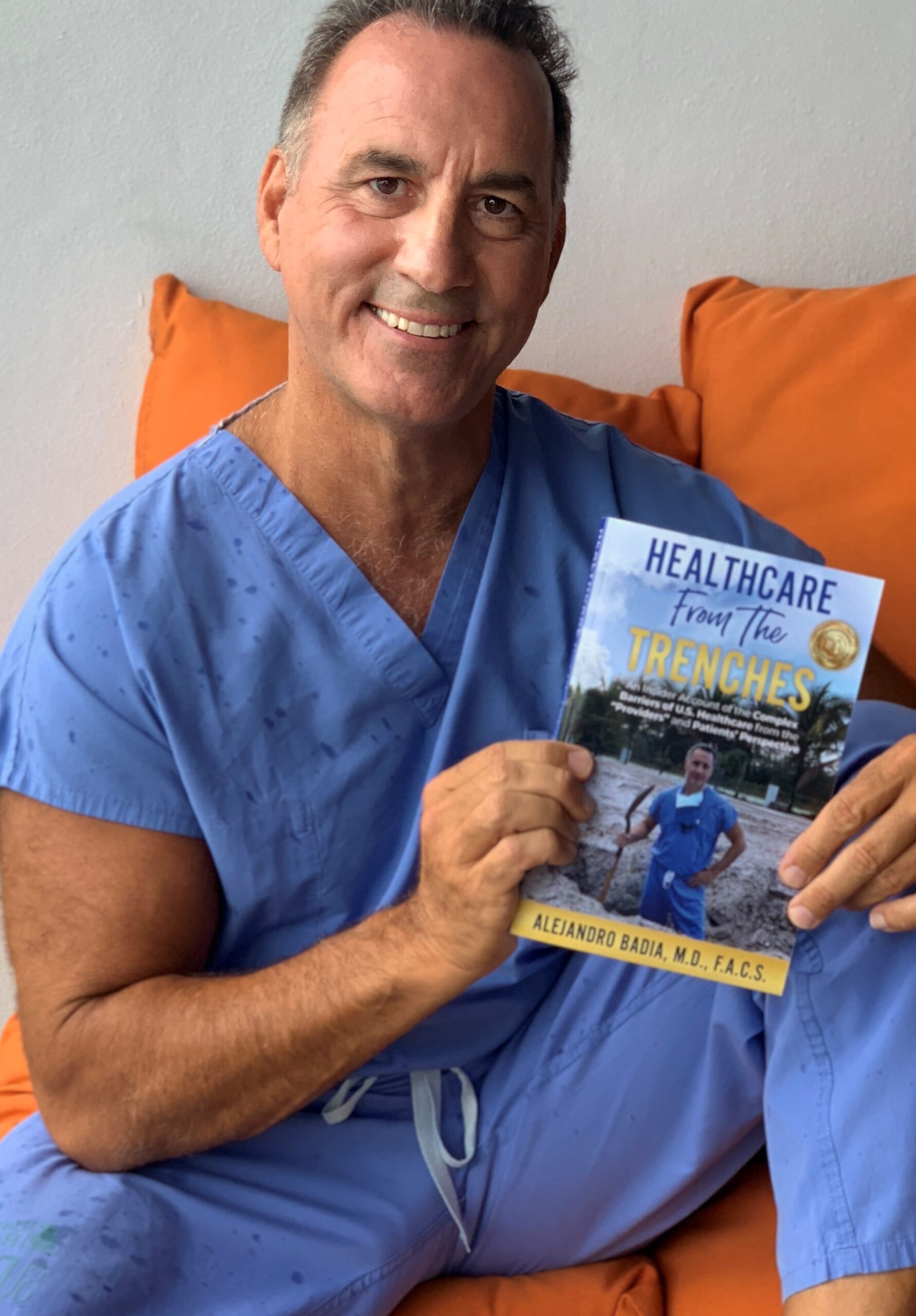 Dr. Badia holding his book Healthcare from the Trenches